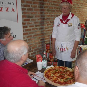 Norma, presenting her pepperoni pizza to the judges (Pete LaChappelle on the left, Peter Reinhart in the center, John Arena on the right, at the Caputo Cup.