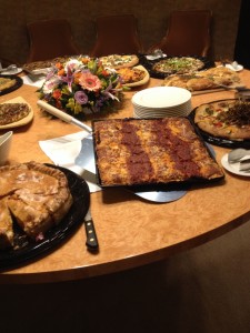 A display of a number of Craig's "tribute pizzas." Not shown, another table right next to this one, loaded with 10 other "tributes." 