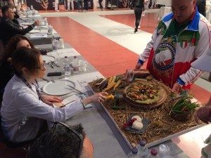 The judges scoring a very intricate pizza