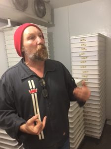 Phil Korshack, surrounded by dozens of dough boxes holding his 72 hour fermentation doughs.