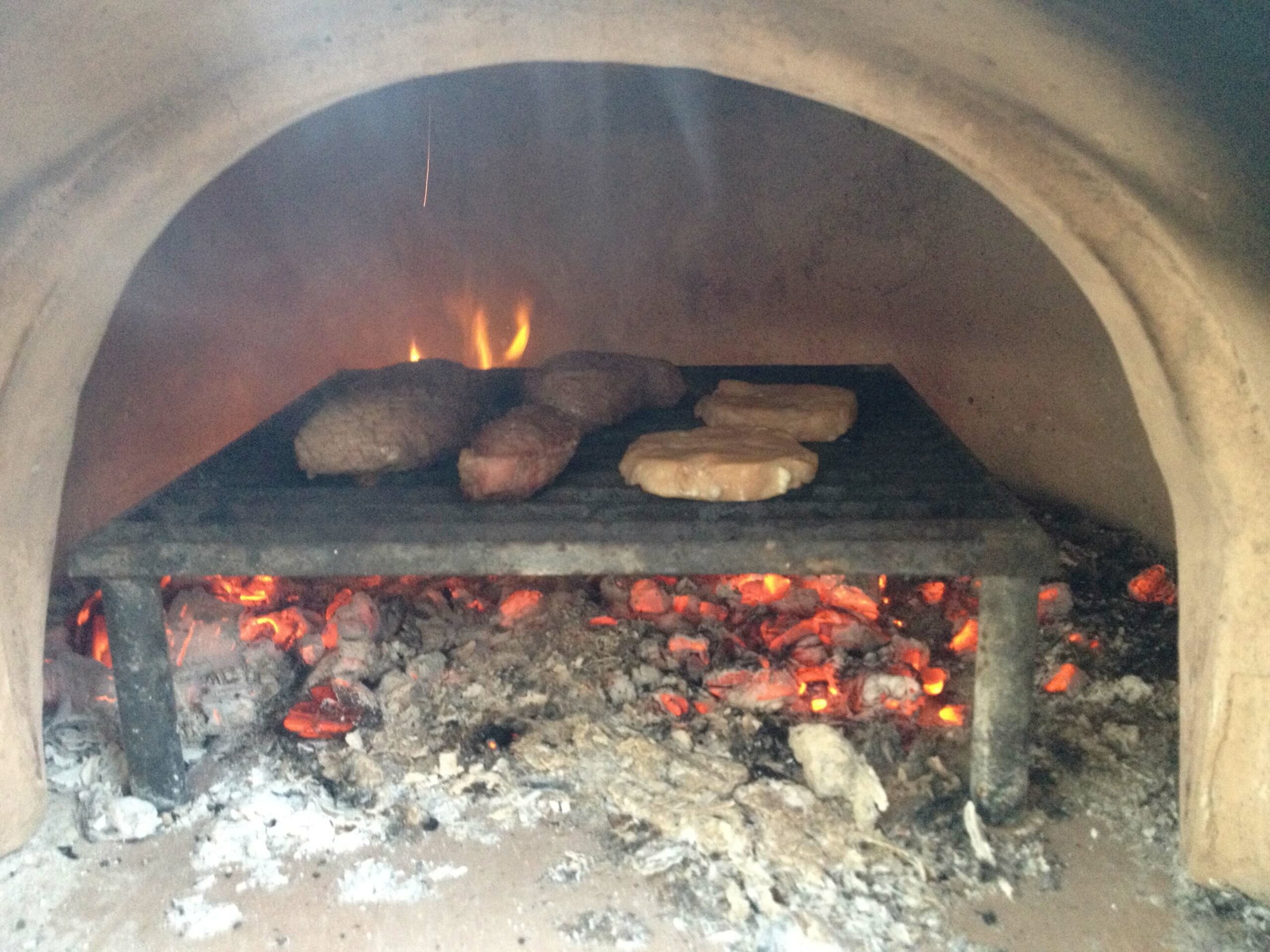 grilling steaks in a pizza oven Forno Bravo. Authentic Wood Fired Ovens