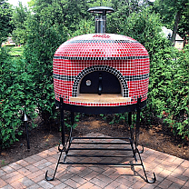 Napolino wood fired pizza oven by Forno Bravo shown on black steel stand with door & thermometer. Black and Red standard tile finish.