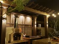 white pompeii pizza oven in outdoor kitchen at night