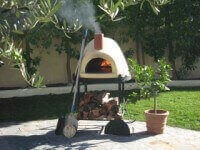 Primavera Outdoor Pizza Oven on Patio with Fire