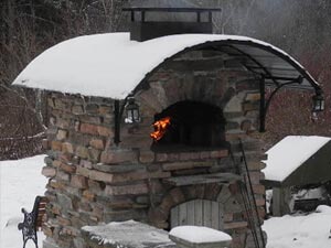 Outdoor brick pizza oven in the snow