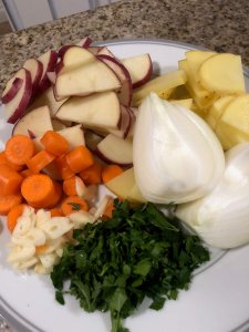 Close up of chunk-cut vegetables on a white plate