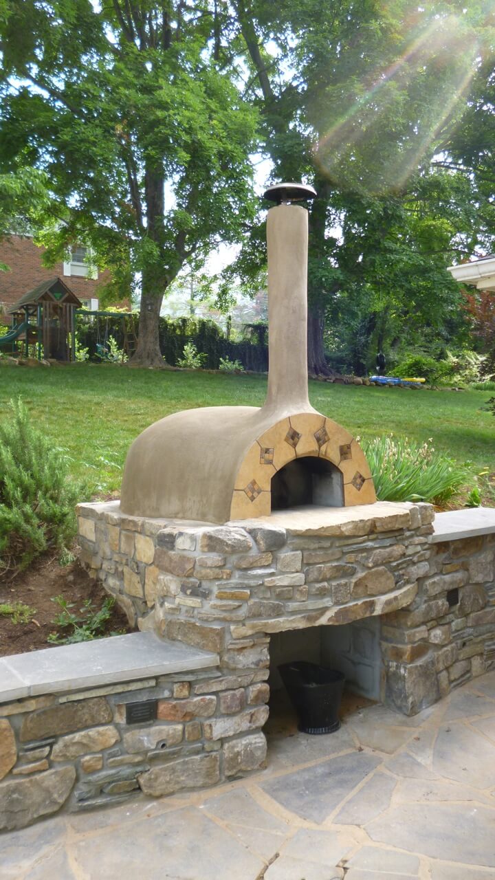 Stucco countertop pizza oven with stone counter - retaining wall - and benches