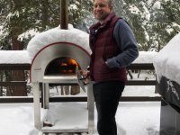 Man in front of a Bella Medio28 Wood Burning Oven In a Foot of Snow