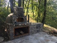 Tan Stucco and Grey Rock-Faced Pompeii Pizza Oven and Prep Counter on a Serbian Hillside in the Woods