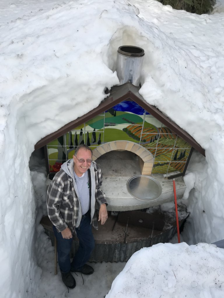 Man in front of pizza oven buried in 12 feet of snow