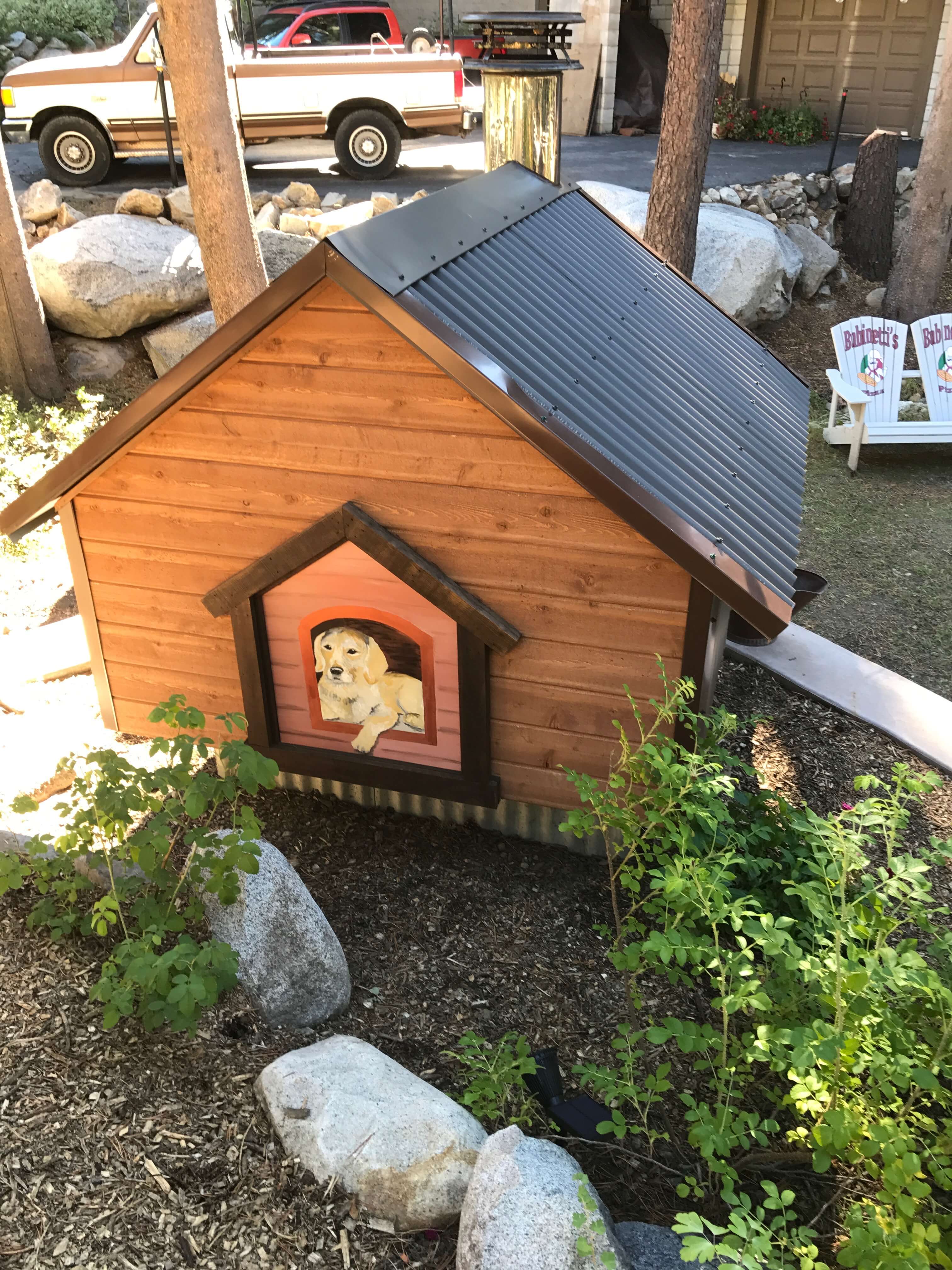 Painting of Golden Lab dog on the back of a dog house style pizza oven enclosure