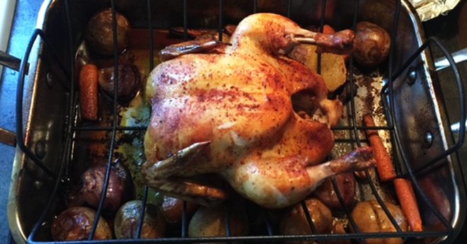 Wood Fired Chicken and vegetables roasting on a rack