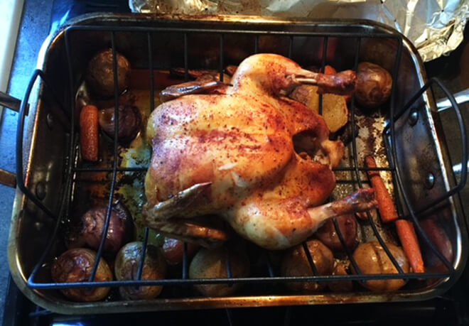 Wood Fired Chicken and vegetables roasting on a rack