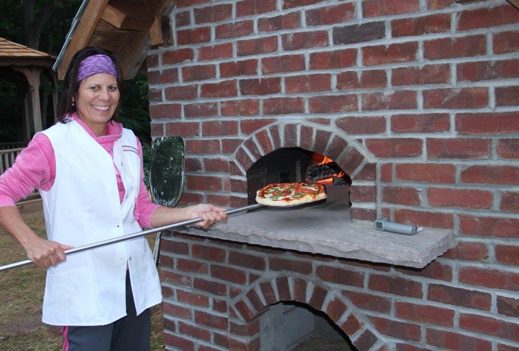 woman with pizza on a peel