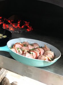 Blue frying pan with wrapped peppers in Bella Wood Fired Oven