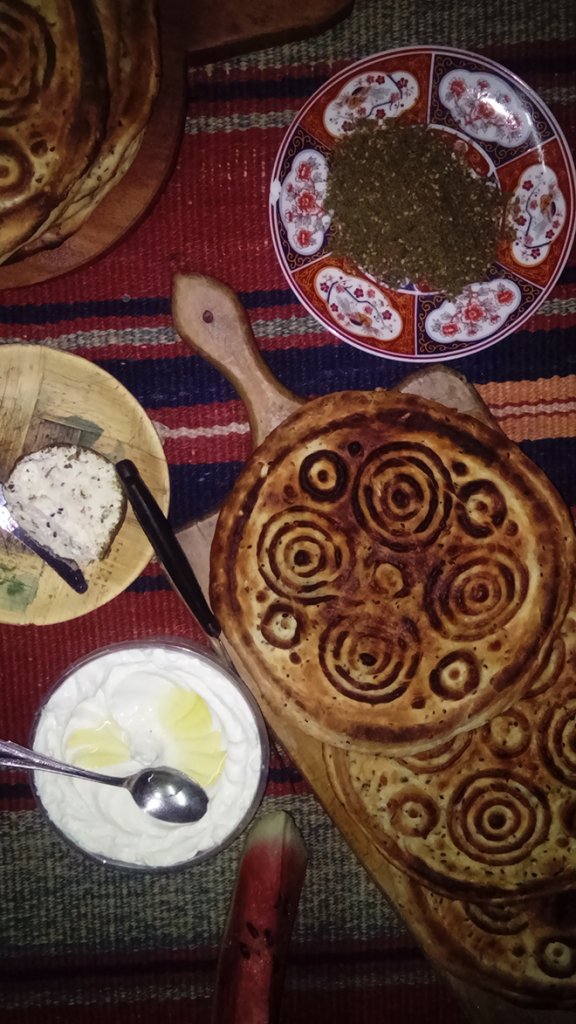 Eid Bread surrounded by bowls of toppings