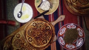 Eid Bread surrounded by bowls of toppings