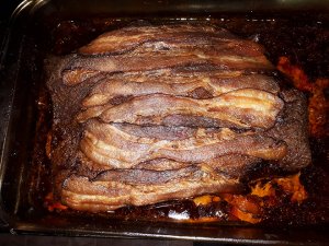 Beef brisket with strips of bacon