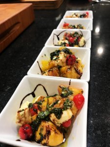 Wood Fired Peach Caprese Salad in white square bowls