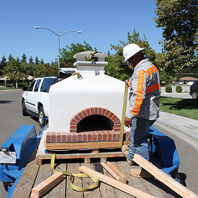 Toscana Oven on Trailer - Man in Safety Vest and hard hat