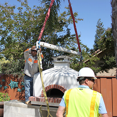 Pizza Oven with Straps and Spreader Bar - Two Men in Safety Vest