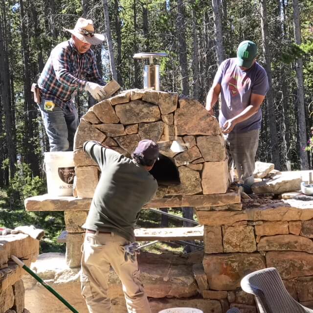 three men on oven installation