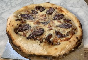 Pizza on marble slab-Cured duck breasts-onions-mushrooms-cheese