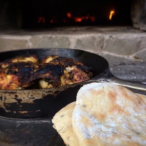 2 pieces naan bread-chicken in cast iron pan