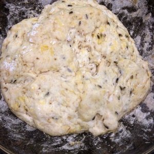 Ball of naan bread dough on floured counter