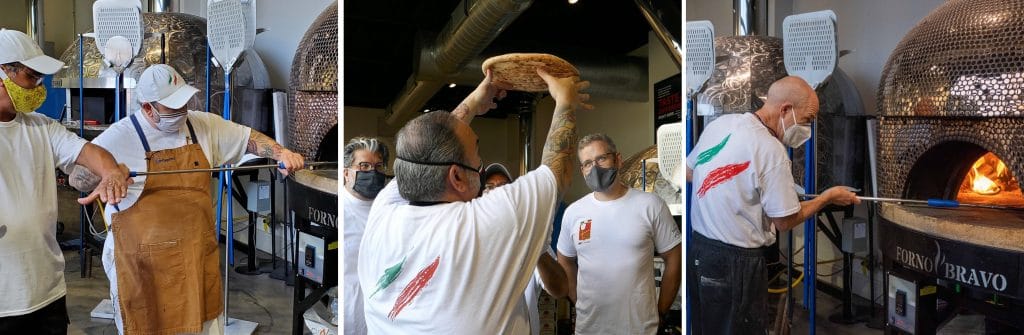 instructor and students working with wood fired oven