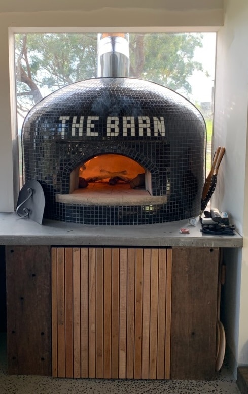 black tiled Casa100 pizza oven with fire