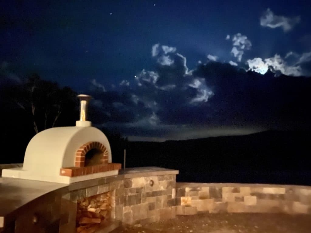 white domed Toscana oven-stone wall- night ski