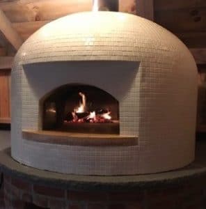 white domed pizza oven with fire