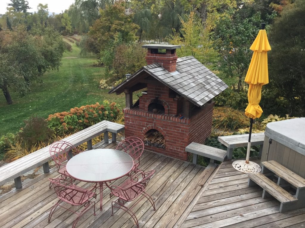 Brick Pizza Oven with roof on an open deck