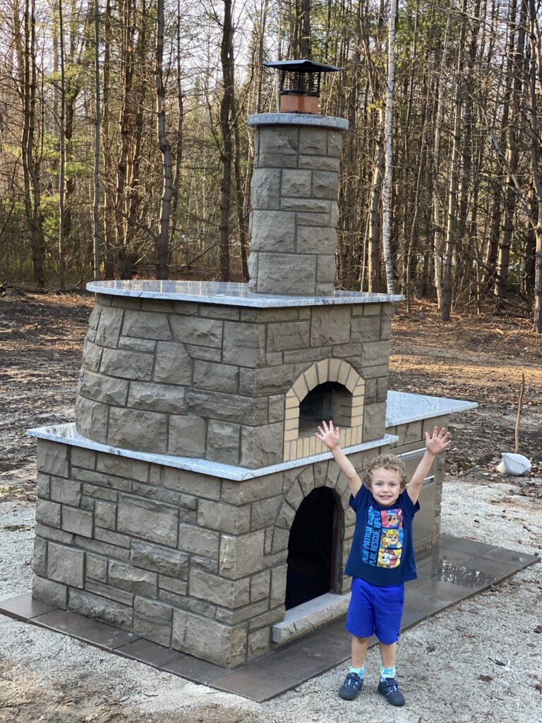 Grey stone Pizza Oven-child with hands in the air