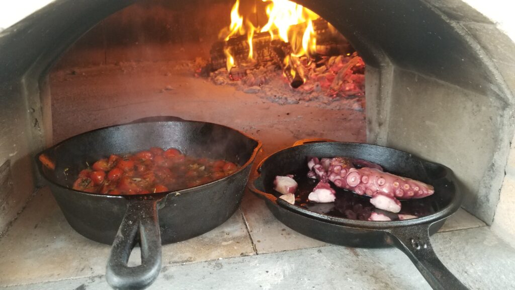 cast iron pans - tomatoes-octopus-fire