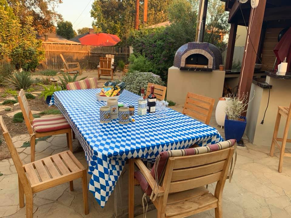 blue pizza oven-table with blue and white checked cloth