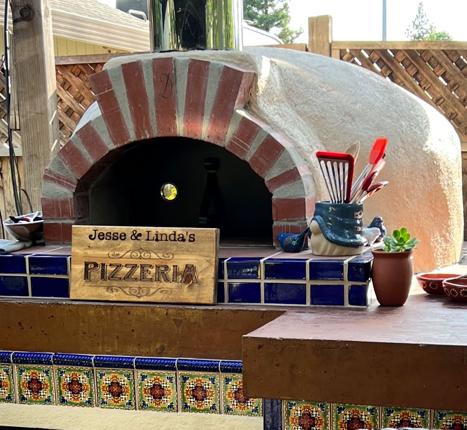 stucco oven_steel door_wood pizzeria sign