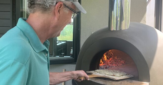 man-pizza-peel in wood fired oven