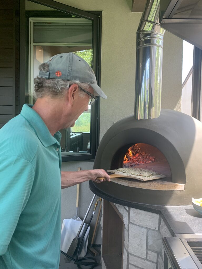 man-pizza-peel in wood fired oven