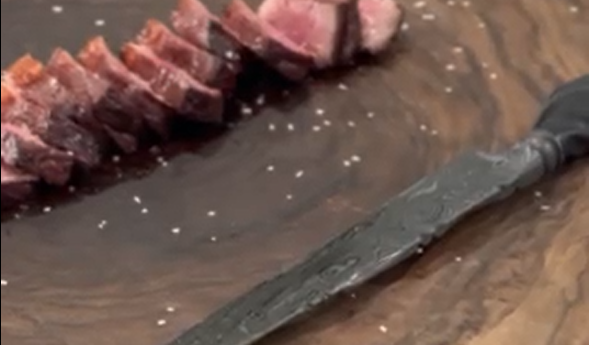 Sliced steak on wood