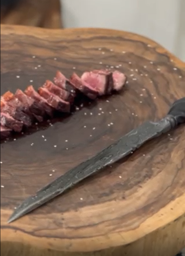 Sliced steak on wood
